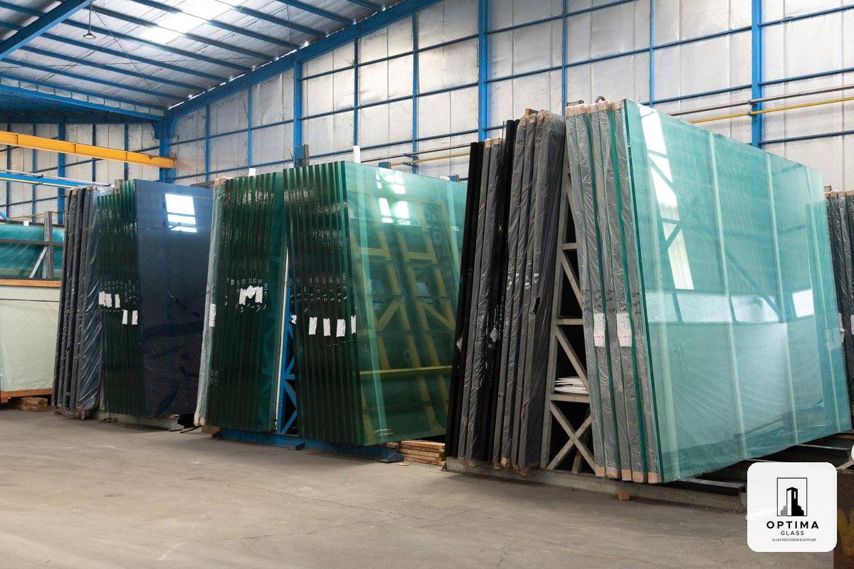 Rak berisi lembaran kaca polos bening dan kaca warna di gudang Optima Glass Cikarang